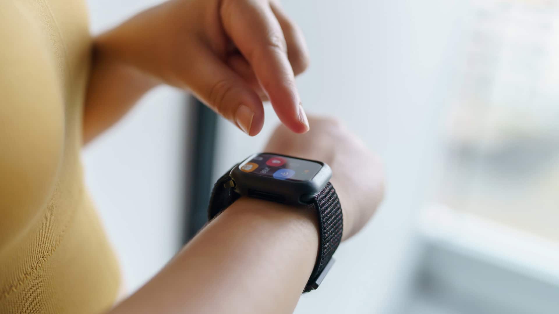 Person touching an application on their smart watch